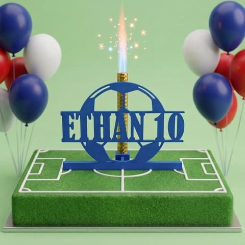 Personalised football cake topper printed with a name and age, holding a lit cake fountain